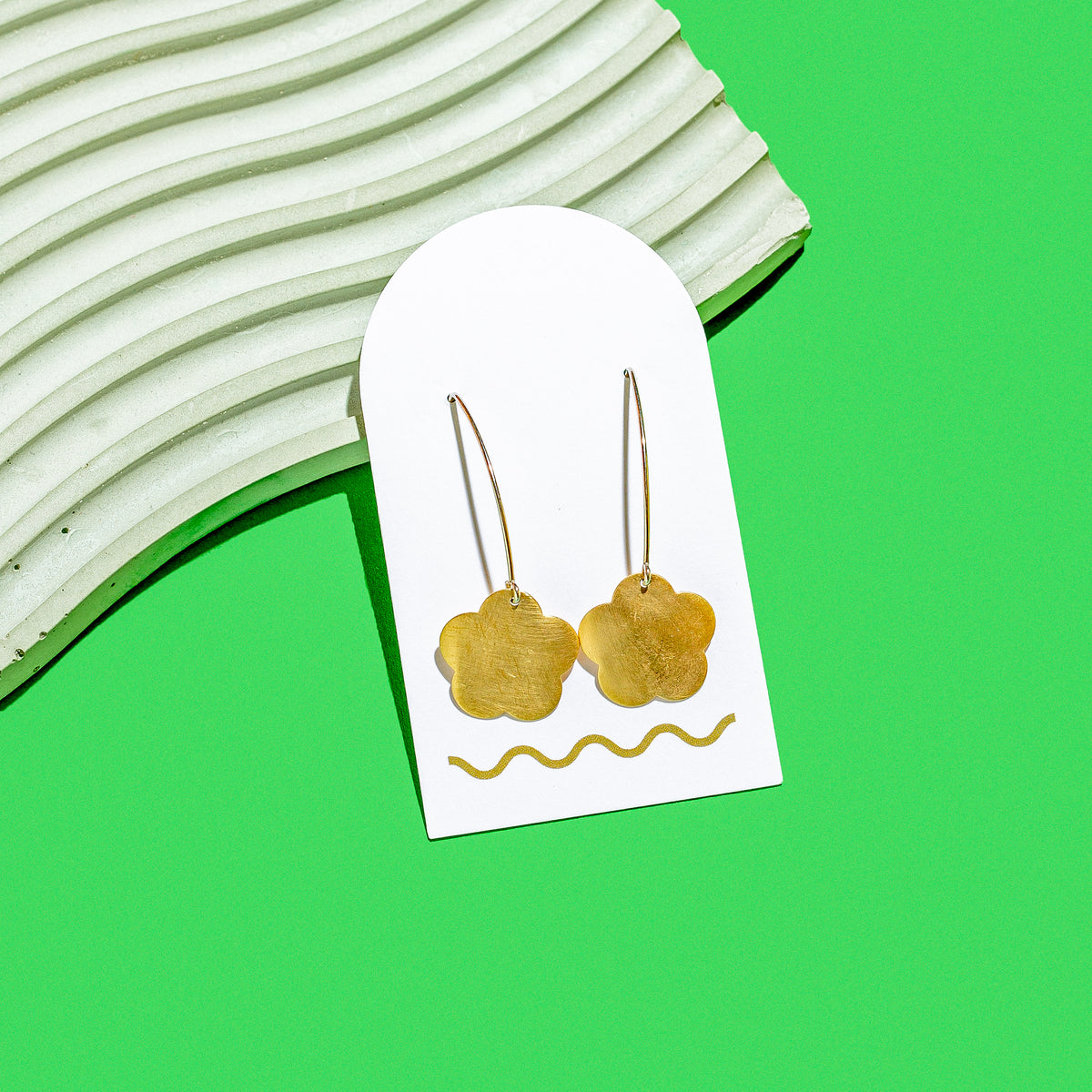 Handcut Brass Earrings on a White Arch Product Card with a squiggle on it - made by Squiggle Cutters in Northwest Arkansas - Local Jewelry in NWA
