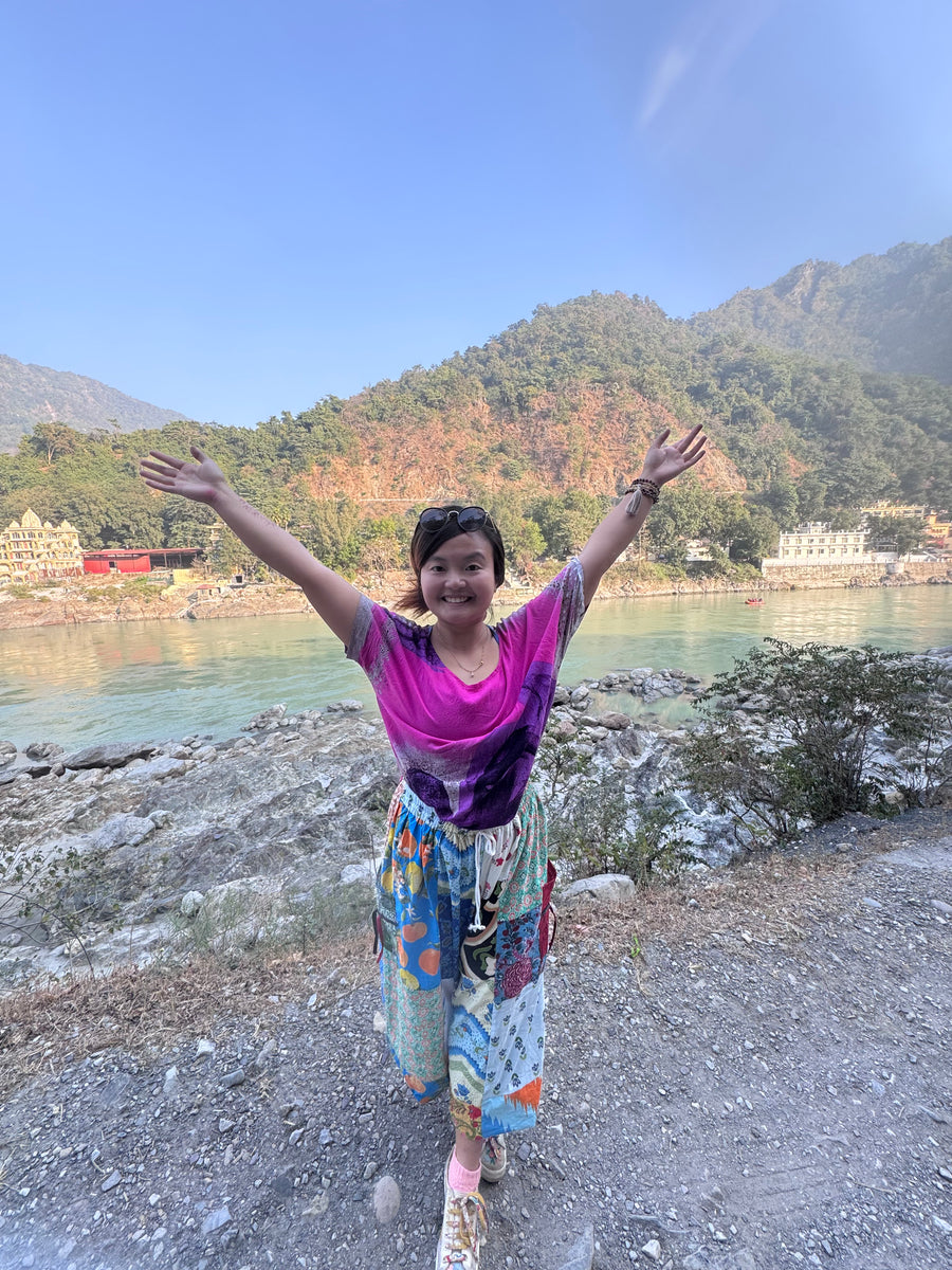 JingJing Ceramics - Artist standing in front of scenic nature background - whimsical ceramic artist in NWA