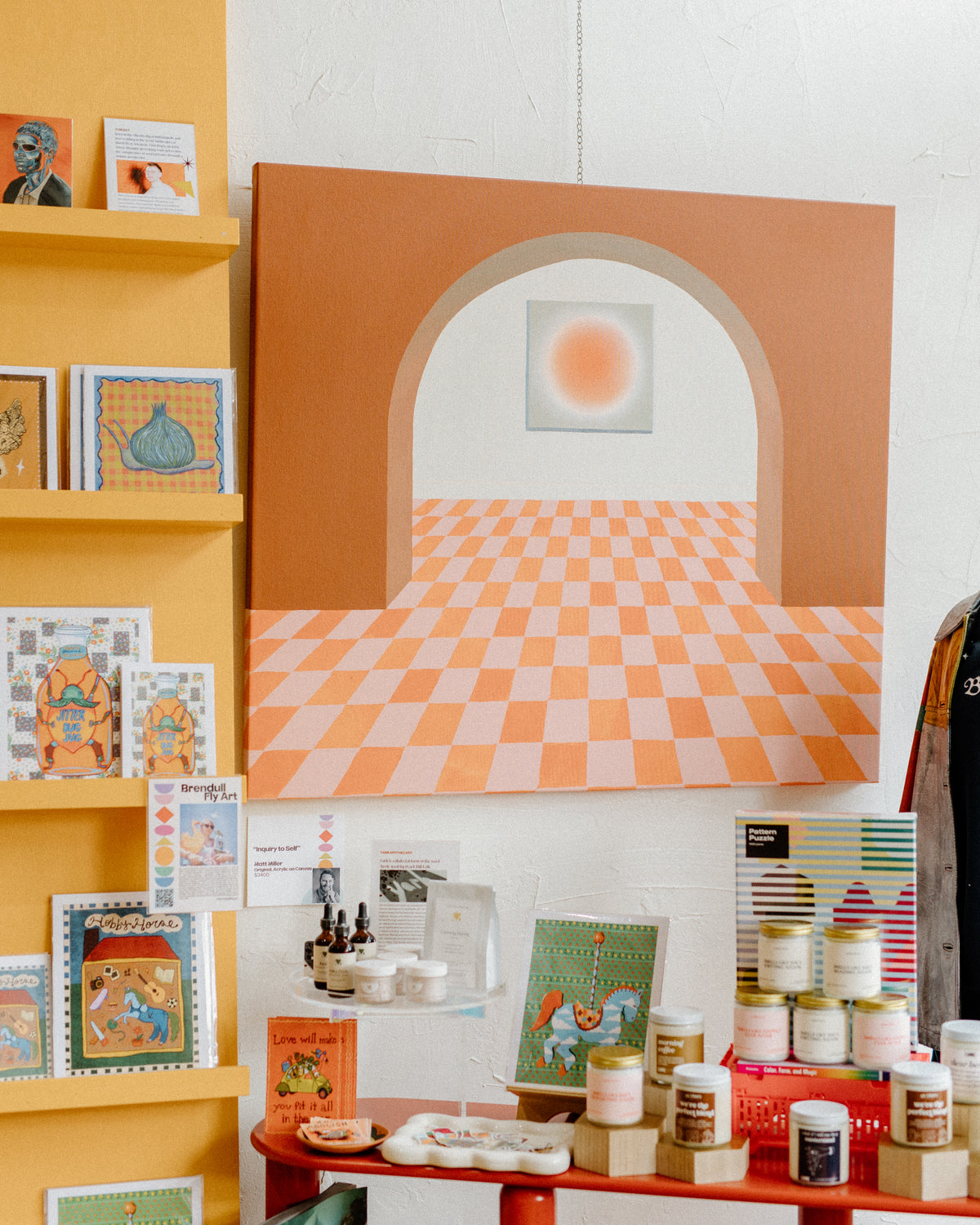 Abstract painting with candles, skincare, art prints, puzzles and other home goods on display in Rogers, Arkansas