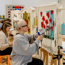 White Women Uses Tuft Gun to Create Red and Blue Poppy Tufted Rug Tufting workshops Handmade tufted rugs Rug making classes Northwest Arkansas